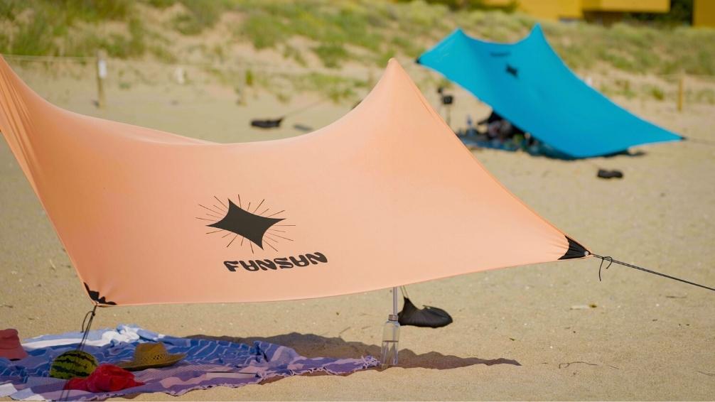 Two FunSun beach canopies in salmon and blue color